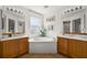 A bathroom featuring a large soaking tub, dual sinks, and bright natural light at 5458 Jessamine Ave, North Port, FL 34291