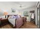 Bedroom with wood floor, a queen bed with purple bedding, and a window at 5458 Jessamine Ave, North Port, FL 34291