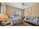A bedroom with a loveseat, ceiling fan, wood floors, and soft, natural lighting at 5458 Jessamine Ave, North Port, FL 34291