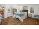 Bedroom featuring wood floors, access to the screened porch via sliding glass door, and windows at 5458 Jessamine Ave, North Port, FL 34291
