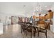 Open concept floorplan with dining room featuring a crystal chandelier and view of the living room at 5458 Jessamine Ave, North Port, FL 34291