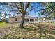 The home is situated on a spacious lot, has a screened in porch, and has a traditional white picket fence at 5458 Jessamine Ave, North Port, FL 34291
