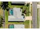 Aerial view of a home with a screened-in pool and lush landscaping at 562 Silk Oak Dr, Venice, FL 34293