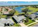 Panoramic aerial shot of a community with mature trees and beautiful lakes at 562 Silk Oak Dr, Venice, FL 34293