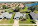 Aerial view of a well-maintained home with mature landscaping near a pond at 562 Silk Oak Dr, Venice, FL 34293
