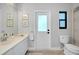 Bright bathroom with decorative nautical art, a white vanity, and a door leading to the outdoors at 562 Silk Oak Dr, Venice, FL 34293
