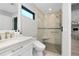 Bathroom featuring a clear glass shower, a window, and modern fixtures at 562 Silk Oak Dr, Venice, FL 34293