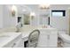 Bathroom featuring marble counters, double sinks, seated vanity, and modern finishes at 562 Silk Oak Dr, Venice, FL 34293