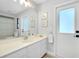 Elegant bathroom showcasing a vanity, decorative art, and a door leading to the outdoors at 562 Silk Oak Dr, Venice, FL 34293