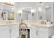 Bright bathroom featuring double sinks, a seated vanity area, and white cabinets at 562 Silk Oak Dr, Venice, FL 34293