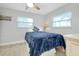 Inviting bedroom featuring two windows for natural light and comfortable blue bedding on a cozy bed at 562 Silk Oak Dr, Venice, FL 34293