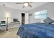 Well-lit bedroom with a large window, walk-in closet, and a convenient workspace with a computer at 562 Silk Oak Dr, Venice, FL 34293