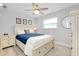 Bright bedroom features a ceiling fan and a comfy bed at 562 Silk Oak Dr, Venice, FL 34293