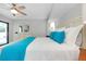 Cozy bedroom showcases white furniture, ceiling fan and bright pillows at 562 Silk Oak Dr, Venice, FL 34293