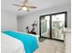 Bedroom with sliding glass door to patio and an exercise bike at 562 Silk Oak Dr, Venice, FL 34293