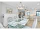 Dining room with a glass table, seating for six, and open concept view to the kitchen at 562 Silk Oak Dr, Venice, FL 34293