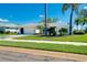 Charming home featuring a lush green lawn and mature tropical landscaping at 562 Silk Oak Dr, Venice, FL 34293