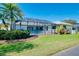 Well-maintained home with a screened-in pool area, beautiful landscaping, and a spacious backyard at 562 Silk Oak Dr, Venice, FL 34293