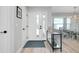 Inviting foyer with a glass console table and an open view of the dining area and front door at 562 Silk Oak Dr, Venice, FL 34293