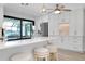 Bright kitchen with white cabinetry, stainless steel appliances, island with marble countertop and stool seating at 562 Silk Oak Dr, Venice, FL 34293