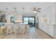 Bright, open kitchen boasts an island with seating, stainless steel appliances, and sliding glass doors at 562 Silk Oak Dr, Venice, FL 34293