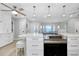 Open concept kitchen with a center island cooktop range and a view of the adjacent open concept living area at 562 Silk Oak Dr, Venice, FL 34293