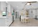 Open concept kitchen with white cabinets, stainless steel appliances, large island with seating, and wood flooring at 562 Silk Oak Dr, Venice, FL 34293