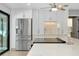 Close up view of a kitchen with stainless steel appliances and a center island with quartz countertops at 562 Silk Oak Dr, Venice, FL 34293