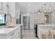 Spacious kitchen with white cabinets, stainless steel appliances, quartz countertops, and a center island with seating at 562 Silk Oak Dr, Venice, FL 34293