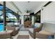 Covered patio with comfortable seating, a dining table, and an amazing view of the backyard pool at 562 Silk Oak Dr, Venice, FL 34293