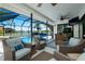 Outdoor lanai featuring a table, chairs, comfortable seating, and a view of the swimming pool at 562 Silk Oak Dr, Venice, FL 34293