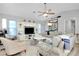 Comfortable living room featuring stylish furnishings, a large entertainment center, and a ceiling fan at 562 Silk Oak Dr, Venice, FL 34293
