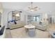 Spacious living room featuring comfortable seating arrangements, modern decor, and sliding doors to outdoor space at 562 Silk Oak Dr, Venice, FL 34293