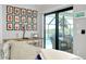 Living room showcasing framed photos above desk with sliding glass doors to screened patio with pool at 562 Silk Oak Dr, Venice, FL 34293