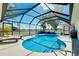 Enclosed in-ground pool with lounge chairs, sun, and clear glass for gorgeous scenic views at 562 Silk Oak Dr, Venice, FL 34293