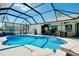 Inviting screened pool area with outdoor seating, a BBQ grill, and a spacious deck for entertaining at 562 Silk Oak Dr, Venice, FL 34293