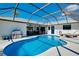 Bright, inviting screened pool area with outdoor dining, lounge chairs, and easy access to the home at 562 Silk Oak Dr, Venice, FL 34293