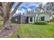 Well-maintained backyard featuring a screened-in patio and lush landscaping around the home at 571 Catalina Isles Cir, Venice, FL 34292