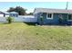 Spacious backyard featuring a white fence, shed, and well-maintained lawn at 599 Carmel Rd, Venice, FL 34293