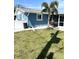 Spacious backyard with a lush lawn, palm tree, and privacy fence at 599 Carmel Rd, Venice, FL 34293
