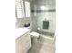 Modern bathroom with glass shower door and white vanity, offering style and functionality at 599 Carmel Rd, Venice, FL 34293