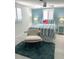 Bright bedroom with a blue accent wall, comfortable bed, and plenty of natural light at 599 Carmel Rd, Venice, FL 34293