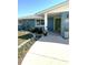 Inviting home entrance with a colorful green front door and well-maintained landscaping at 599 Carmel Rd, Venice, FL 34293