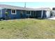Charming single-story home featuring a well-manicured lawn and blue exterior at 599 Carmel Rd, Venice, FL 34293