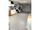 Spacious garage with epoxy flooring, storage cabinets, and an open layout at 599 Carmel Rd, Venice, FL 34293