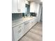 Bright kitchen with white cabinets, stainless steel appliances, and beautiful countertops at 599 Carmel Rd, Venice, FL 34293