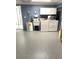 Functional laundry room with a washer, dryer, sink, and ample storage space at 599 Carmel Rd, Venice, FL 34293