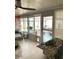 Bright sun room with large windows offering a view of the outdoor patio and pool area at 599 Carmel Rd, Venice, FL 34293