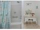 Bathroom featuring a tub with shower, a vanity table with ornate mirror and chair at 601 Apalachicola Rd, Venice, FL 34285