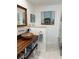 Stylish bathroom featuring a unique sink, wood accents, modern decor, and a glass-enclosed shower at 601 Apalachicola Rd, Venice, FL 34285